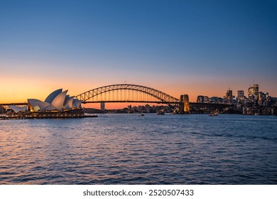 View of Sydney Harbour with Sydney Opera House and Sydney Harbour Bridge from Mrs Macquarie's Chair during sunset hour - Powered by Shutterstock