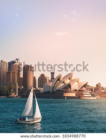 View of Sydney Opera House with sailboat 