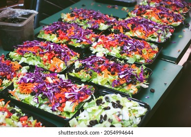 A View Of A Table Filled With Salad Meal Prep Containers.