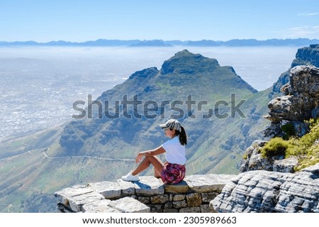 view from the Table Mountain in Cape Town South Africa, view over the ocean, and Lion's Head from Table Mountain Cape Town, Asian women hiking in the mountains of Cape Town South Africa