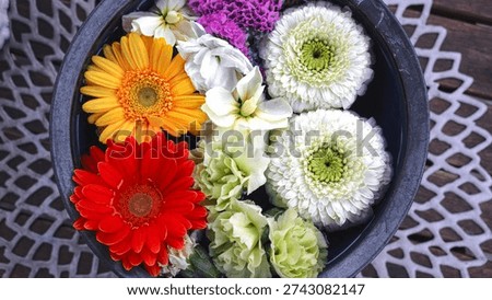 View of a table vase adorned with multiple flowers
