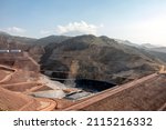 View of the tailings dam or waste dam construction and sealing membrane assembly for mining site.