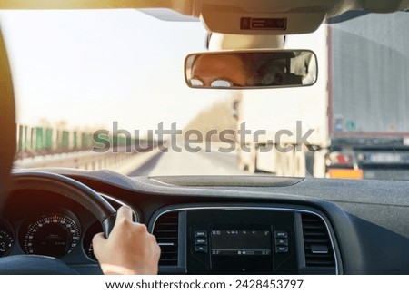 View taken from inside a vehicle overtaking a large vehicle on the highway