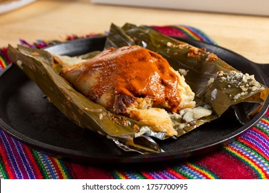 A view of a tamal guatemalteco, in a restaurant or kitchen setting.