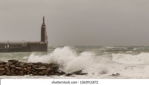 View of the Tarifa harbor statue in Tarifa on a cloudy windy day, Cadiz, Andalusia, Spain
