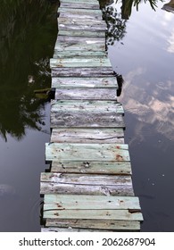 view of a textured foot path over very calm water 
