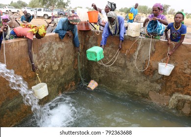 View of thirsty people drawing water in a reservoir with buckets and ropes. The scene takes place in North Senegal in a village of Louga region. The picture has been taken on 13rd november 2015.   