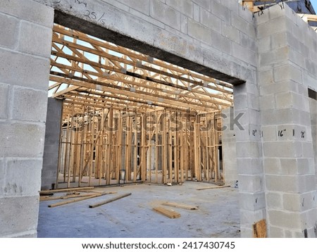 View Through Cinder Block Wall Opening to Wood Wall and Roof Frames
