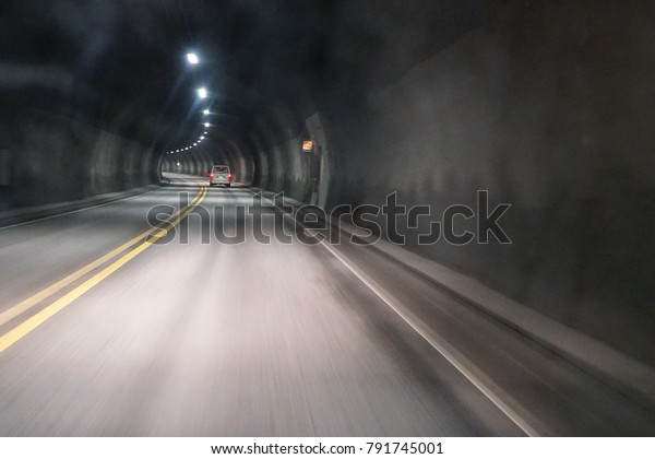 View through fogged car window in tunnel while\
driving in winter time.