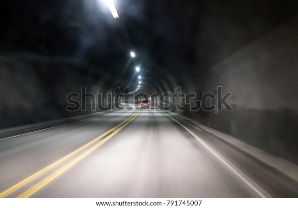 View through fogged car window in tunnel while\
driving in winter time.