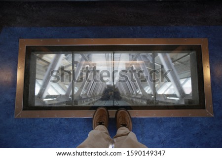 View through glass floor in elevator of Sky Tower, Auckland, New Zealand