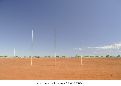 View Through Goal Posts Of Dry Dusty Australian Rules Football Oval In Outback Billiluna (Kururrungku) Western Australia 