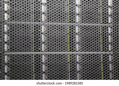 View through the grate to server rack in data center. Storage with SATA hard drives