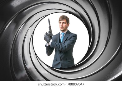View Through Gun Barrel On Agent With Pistol.