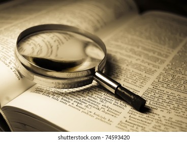 View through loupe at book - Shutterstock ID 74593420