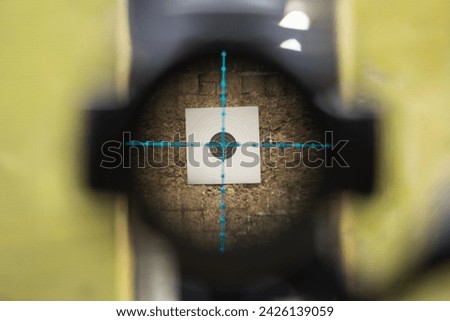View through the optical sight of a sniper rifle at a target in a shooting range. Close up photo. 