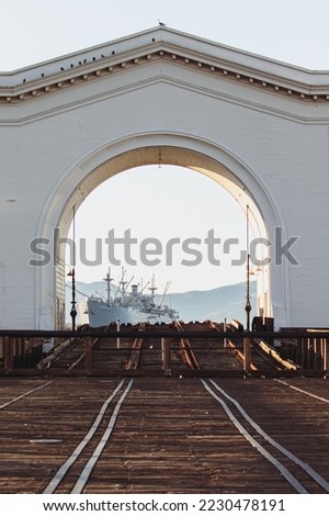 A view through the Pier 43 arch revealing SS Jeremiah O'Brien.  San Francisco, California, USA