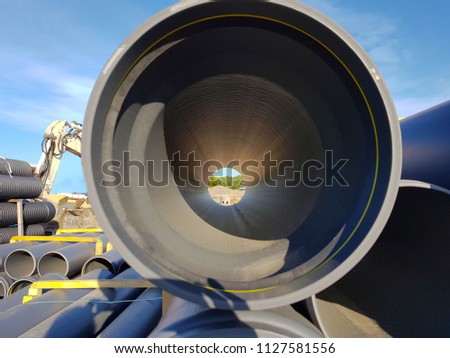 View through the pipe on the construction site.