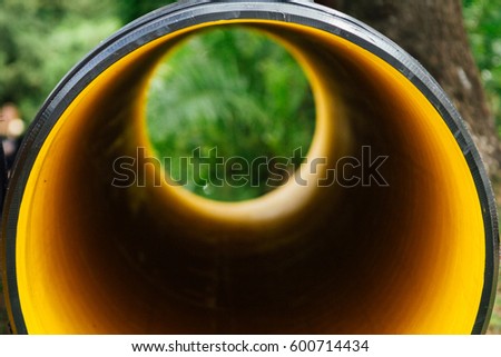 View through a plastic drain spout