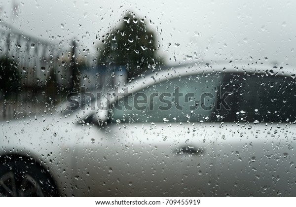 view\
through the side window of the car on a rainy\
day