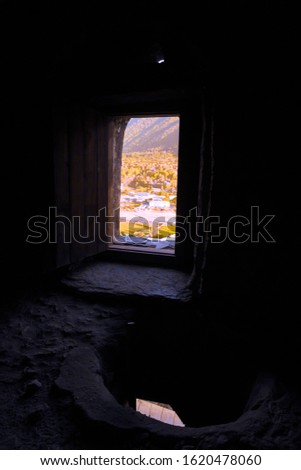View through a small window of an ancient house in Ushguli village in Svaneti. Georgia. Toned.