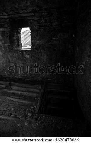 View through a small window of an ancient house in Ushguli village in Svaneti. Georgia. Toned.