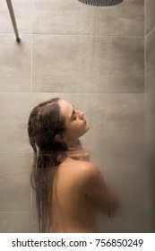 View Through Steamy Shower Glass Cabin On A Woman Washing Body 