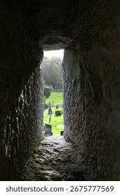 View Through a Stone Passageway That Is Surrounded by Lush and Vibrant Greenery All Around