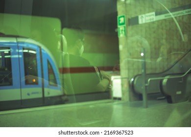 View Through The Train Window In The Subway. Passenger Reflection With Face Masks On Glass.