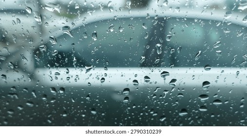 A view through a wet side window of a car at another car parked nearby
