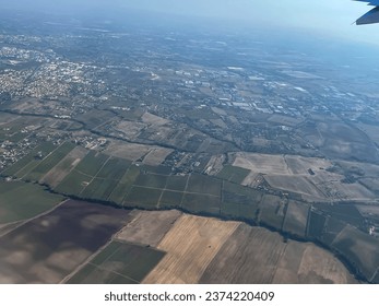 View through the window of an airplane while flying at high altitude and with the sun in front of it.