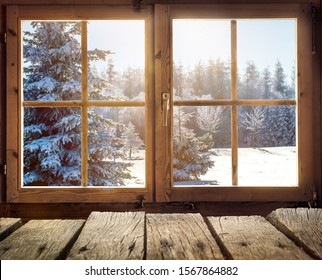 View through the window of a cottage into a snow-covered winter forest - Powered by Shutterstock
