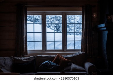 View through the window from cozy wooden cabin to snowy mountains during winter. Ski center accommodation.  - Powered by Shutterstock