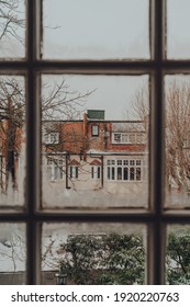 View through the window frame of a snowy day, from inside the house, selective focus.