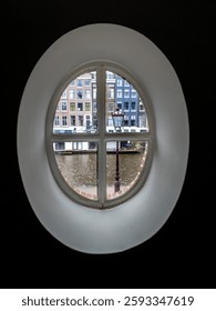 View through windows in the shape of ellipse from the H`Art museum, Amsterdam, Netherlands