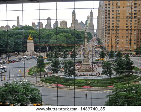 View through a window-wall of  Central Park with the Upper East Side on the horizon, from high up in The Shops at Columbus Circle complex in New York City 