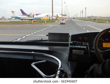 The view through the windshield of the bus at the airport. Transporting passengers to the aircraft on runway.