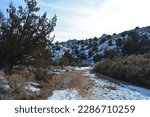 view through the windshield of an SUV, driving the snowcapped and muddy house rock valley dirt road to the buckskin gulch trailhead at the stateline Utah - Arizona, United States of America, USA