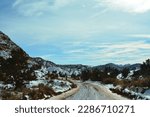 view through the windshield of an SUV, driving the snowcapped and muddy house rock valley dirt road to the buckskin gulch trailhead at the stateline Utah - Arizona, United States of America, USA