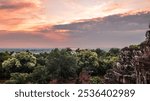 View of thw West Baray reservoir and the West Mebon temple from the Phnom Bakheng temple terrace in Cambodia at sunset