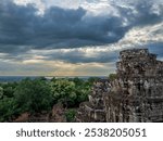 View of thw West Baray reservoir and the West Mebon temple from the Phnom Bakheng temple terrace in Cambodia at sunset