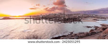 View from tidal island of Grand Be to city of Saint Malo at sunrise, high tide, Brittany, France.