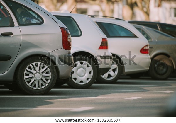 View of tightly\
packed cars in parking\
lot.