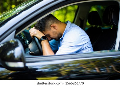 View Of Tired Businessman Driving A Car