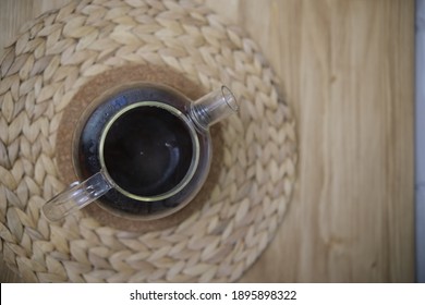 The View From The Top Brew Tea With Boiling Water. Tea Leaves Open. Brown Color. Blurred Kitchen Background With Plants Cork Board.. Tea Ceremony. Close-up. Bokeh 4k