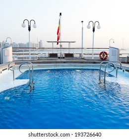 View Of Top Deck Of Cruise Ship With Pool.