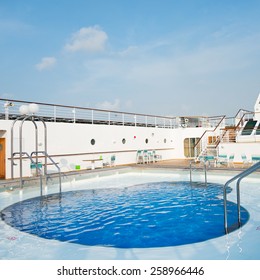 View Of Top Deck Of Cruise Ship With Pool.