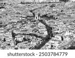 View from the top of the Eiffel Tower in Paris (France) of the 8th, 16th and 17th arrondissements with the “Arc de Triomphe” and the famous “Etoile” traffic circle and the “Champs-Elysées” boulevard.