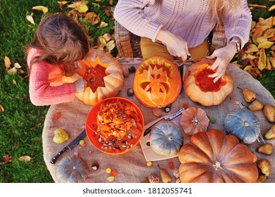 View From Top Of Family Carving Pumpkins For Halloween