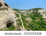View from top of Inkerman cave monastery. Classic Crimean white rocks with plateau and caves of ancient monks inside cliff on left side. Shot near city Inkerman, Crimea